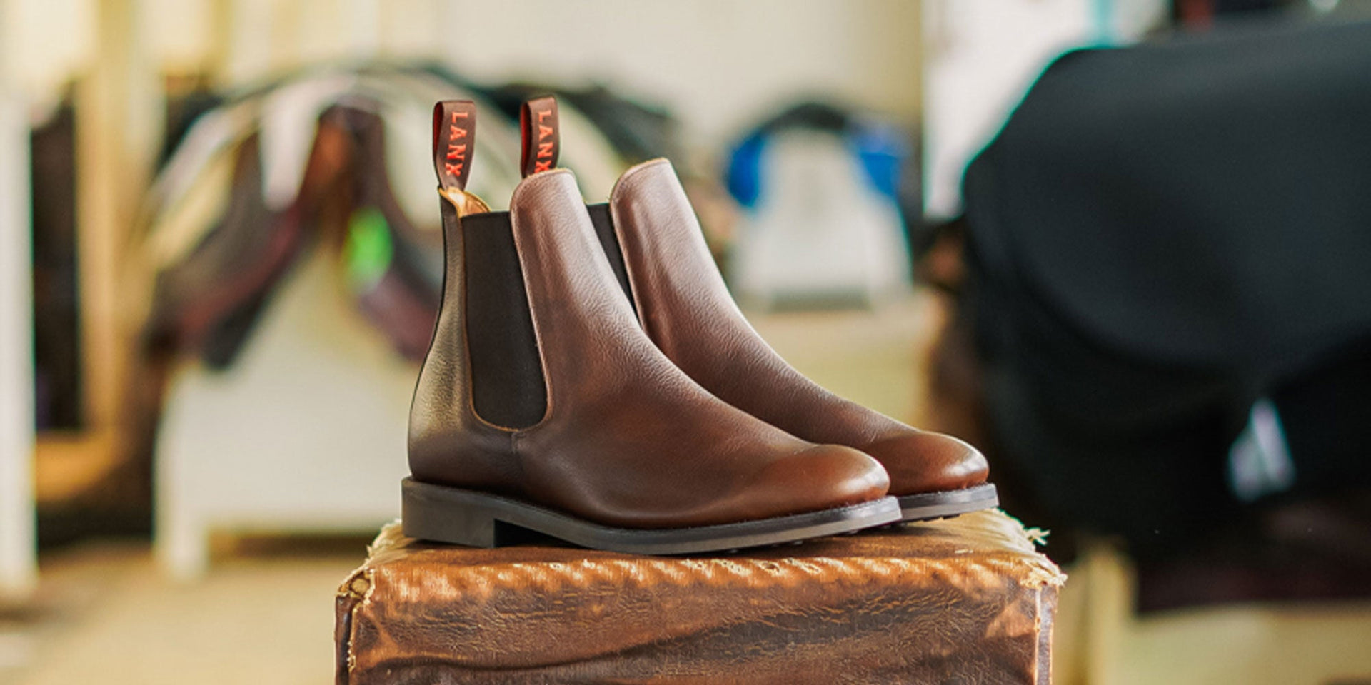 A man wearing the LANX Mitton chelsea boots in acacia distressed brown.