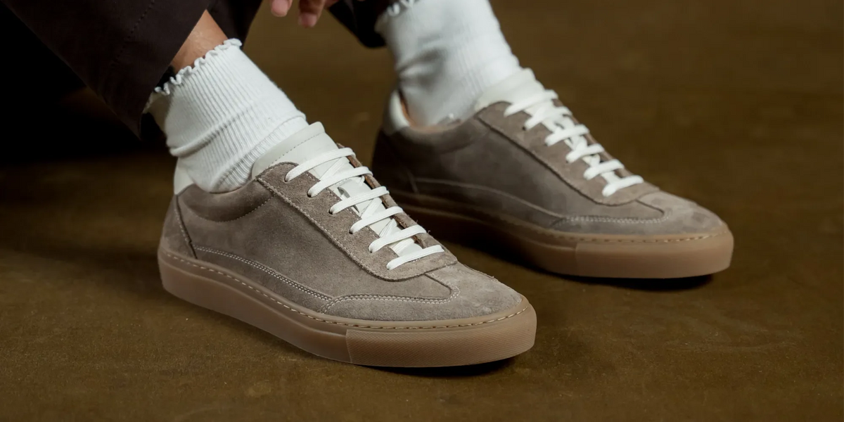 A collection of Cheadle sneakers on a leather backdrop