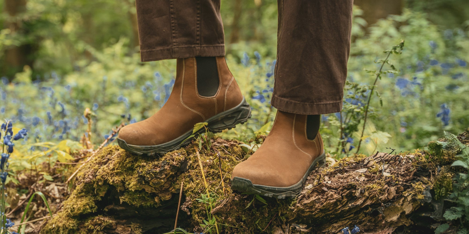 A man outside on a pier wearing the LANX Ribchester walking boots with a Vibram sole.