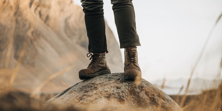 A man outside on a pier wearing the LANX Ribchester walking boots with a Vibram sole.