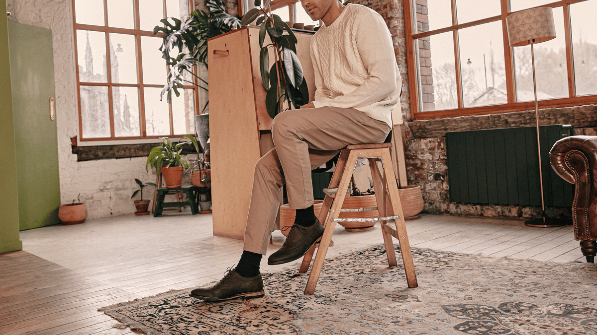 A man sat on a step ladder, wearing the LANX Shireburn // Brown Distressed, oxford brogues.