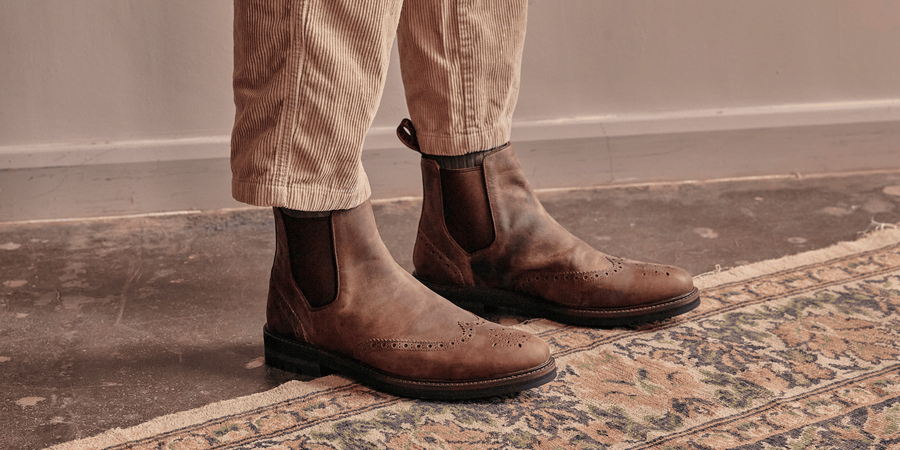 A man wearing the LANX Mitton chelsea boots in acacia distressed brown.