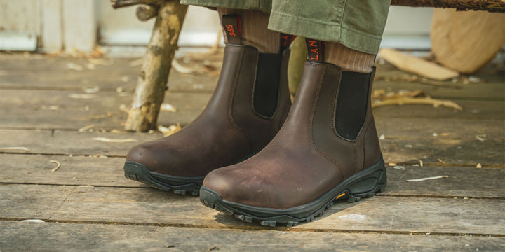 A man outside on a pier wearing the LANX Ribchester walking boots with a Vibram sole.