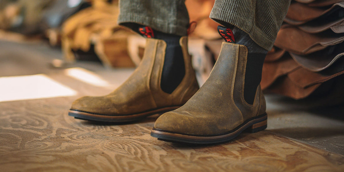 A man wearing the LANX Mitton chelsea boots in acacia distressed brown.